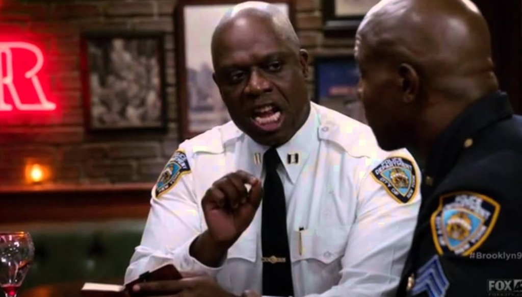Captain Holt ushering the word "Pain" to Sergeant Jeffords from Brooklyn 99